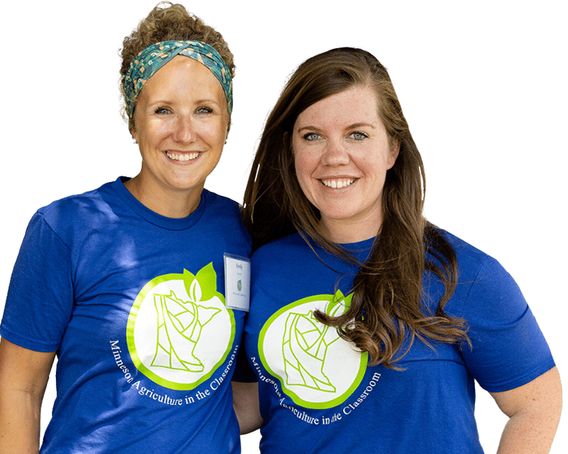 Two women in blue t - shirts standing next to each other