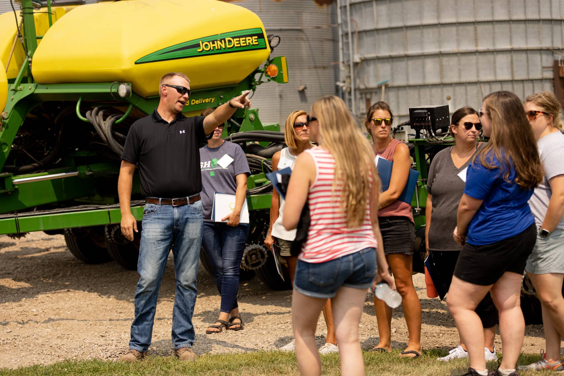K 12 Educators Gather In Front Of A Tractor