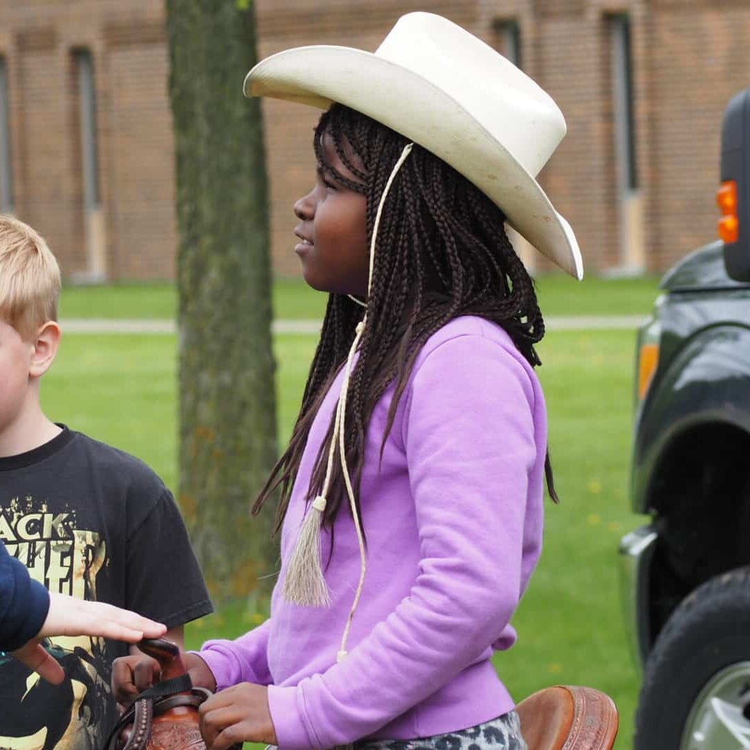 A Girl Representing The Foundation Wearing A Cowboy Hat